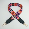 Close-up of adjustable wide woven shoulder strap with colorful geometric patterns - Orange Check + Green Leather Trim