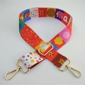 Detail of colorful ethnic style bag strap with gold metal hooks and Dino Daily print - Orange Cartoon