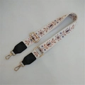 Close-up of ethnic floral embroidery on adjustable wide shoulder bag strap with gold buckle - Silver Clasp / No. 3 White Brown Flower with Black Leather
