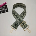 Detail of adjustable wide shoulder strap featuring green snake print and gold hardware - Snake Print