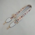 Close-up of white ethnic floral embroidery strap with golden metal swivel hooks - No. 2 White Brown Flower with White Leather