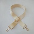 Close-up of cream nylon bag strap featuring gold metal lobster clasps and twill texture - Silver Clasp / Beige