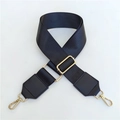 Macro detail of adjustable black woven wide shoulder strap with gold metal swivel hooks - Black Nylon Style / Silver Clasp