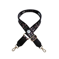 Detail of floral ethnic embroidery on adjustable wide crossbody bag strap with gold hooks - Silver Buckle / Black & White Flowers + Black Leather