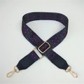 Close-up of ethnic style purple woven strap with geometric patterns and gold metal hooks - Purple Pattern + Black Leather Trim
