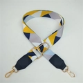 Macro shot of colorful geometric woven bag strap with golden metal lobster clasps - Yellow Rhombus + Black Leather