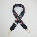 Close-up of wide adjustable bag strap with colorful butterfly patterns and gold hardware - Butterfly
