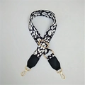 Detail of adjustable leopard print shoulder strap with black leather ends and gold hooks - Speckled White