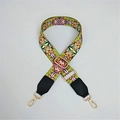 Close-up of geometric pattern strap with gold metal hooks and black leather ends - Floral Green