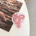 Detailed top view of pink rhinestone bow phone grip holder on a desk with a magazine - Full Zirconia Bow / Pink / Magnetic
