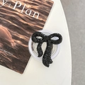Macro shot of black rhinestone bow phone grip holder on a minimalist magazine background - Full Zirconia Bow / Black / Magnetic