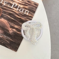 Close-up of sparkling rhinestone bow phone grip holder with crystals on a desk - Full Zirconia Bow / Iridescent / Magnetic