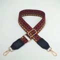 Close-up of adjustable woven shoulder strap with red black geometric pattern and gold clips - Coffee Weaving with Black Leather