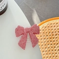 Macro shot of pink rhinestone bow phone grip holder with sparkling crystals on white desk - Starry Resin Rhinestone Bowknot / Pink / Adhesive