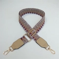 Detail of colorful woven shoulder strap with orange geometric patterns and gold metal buckle - Khaki Weaving with Khaki Leather