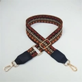 Close-up of ethnic style woven bag strap with golden metal buckles and PU leather ends - Contrast Brown with Black Leather