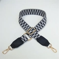 Detail of adjustable woven shoulder strap with black white pattern and gold metal hooks - Black Weaving with Black Leather