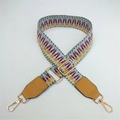 Detail of colorful ethnic woven bag strap with golden metal swivel hooks and adjuster - Light Weaving with Yellow Leather