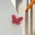 Macro view of crystal-encrusted pink butterfly phone grip on a white surface - Adhesive / Pink