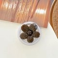 Macro view of dark brown floral phone grip with glossy vintage texture on white desk - Magnetic Ink-wash Cherry Blossom - Caramel