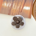 Detailed top view of a brown flower-shaped phone grip with a speckled texture - Magnetic Ink-wash Cherry Blossom - Coffee