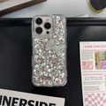 Close-up of luxury rhinestones and pink bow design on iPhone protective case - Model: i17 Pro Max / White