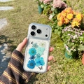 Close-up of clear iPhone case with real blue flowers, silver glitter, and butterfly detail - iPhone 7/8/SE 2020 / Butterfly & Flower - Blue