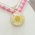 Macro view of a yellow resin phone grip shaped like a button with colorful heart sequins - Magnetic Large Button Cloud Pearlescent / Yellow