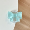 Close-up of blue bow phone grip with silver glitter and Gift For You text on Magsafe base - Mint Green