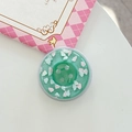 Macro shot of mint green donut phone grip with resin clouds and glitter details - Magnetic Large Button Cloud Pearlescent / Dark Green