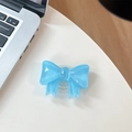 Detail showing a light blue resin bow phone grip with a retractable transparent base - Large Bow Bracket / Crystal Blue