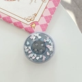 Detailed view of a cute resin button phone socket with glitter and colorful cloud sequins - Magnetic Large Button Cloud Pearlescent / Silver Grey