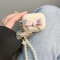 Detail of cream AirPods Pro case with pink 3D bow and pearl chain wrist strap - Pink Big Bow Pearl Chain (Airpods 1/2 Gen) / Off White