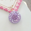 Macro detail of purple button-style phone grip with embossed clouds on white desk - Magnetic Large Button Cloud Pearlescent / Purple