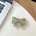 Close-up of sage green bow-knot collapsible phone grip holder with resin glossy finish - Large Bow Bracket / Crystal Dark Green