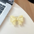 Detail of yellow bow phone grip showing the transparent expandable base on white surface - Large Bow Bracket / Crystal Light Yellow