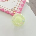 Close-up of a light green translucent button phone grip with colorful cloud dots detail - Adhesive Large Button Cloud Pearlescent / Light Green