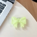Detail of translucent pastel bow phone socket grip on a clean white desk setup - Large Bow Bracket / Crystal Fluorescent Green
