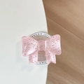 Close-up of pink glitter bow Magsafe grip with Gift For You text on white table - Pink