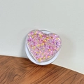 Macro shot of heart-shaped phone grip with pink and purple glitter in clear acrylic - Magnetic Sequin Heart No. 8