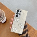 Detailed view of white pearlescent phone case with 3D bows and rhinestones for Samsung S24 - Electroplated Frame-Glitter White-Triple Bow-White / Samsung A16