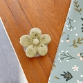 Detail view of a 3D light green flower phone grip holder with marble texture on wooden desk - Cherry Blossom Socket - Ink Style - Light Yellow