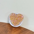 Detail of heart-shaped phone grip with sparkling pink and gold sequins on a wooden desk - Magnetic Sequin Heart No. 12