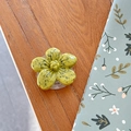Macro detail of yellow flower phone grip with artistic black spots on a wood desk - Cherry Blossom Socket - Ink Style - Dark Yellow