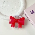 Close-up of a glossy red translucent bow magnetic phone grip on an aesthetic tray - Rose Red