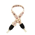 Close-up of adjustable wide woven shoulder strap with floral patterns and gold hardware - White Floral with Black Leather