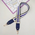 Detail view of purple striped woven wide bag strap with gold metal hooks and hardware - Blue