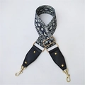 Detailed view of adjustable snake skin pattern wide bag strap with gold studs and hardware - Snake Print