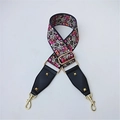 Detail of adjustable bohemian embroidered bag strap with floral pattern and gold hardware - Floral