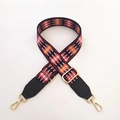 Close-up of ethnic geometric pattern webbing strap with gold metal lobster clasps - Black and Red Rhombus + Black